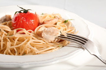 Delicious chicken spaghetti with tomato on white plate