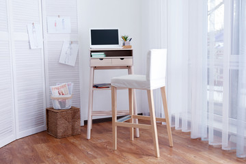 High wooden table as stand up work place in modern interior