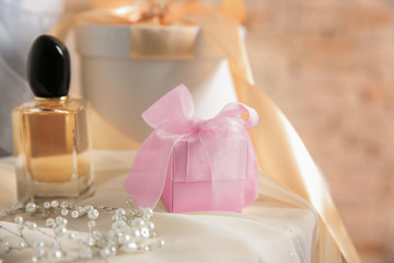 Fototapeta na wymiar Table with gift boxes and perfume for wedding day
