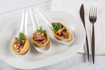 Plate with stuffed pasta on wooden table