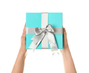 Hands holding beautiful gift box on white background