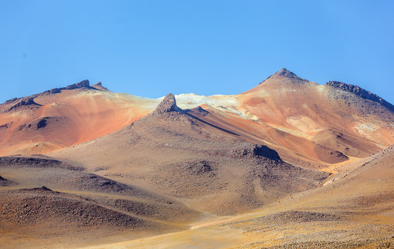Desert plateau of the Altiplano (an ancient collapsed volcano on background) - Bolivia, South America