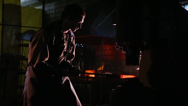 Red hot iron lingot on a press machine