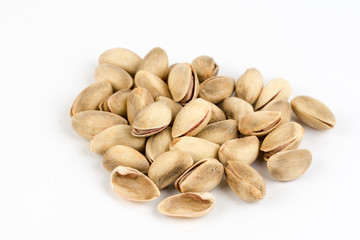Pile of roasted pistachio over white background