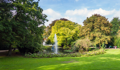 Fountain in green Queen Astrid park in Brugge, Belgium