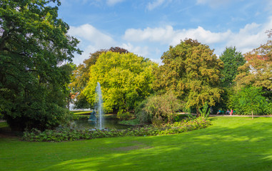 Fountain in green Queen Astrid park in Brugge, Belgium