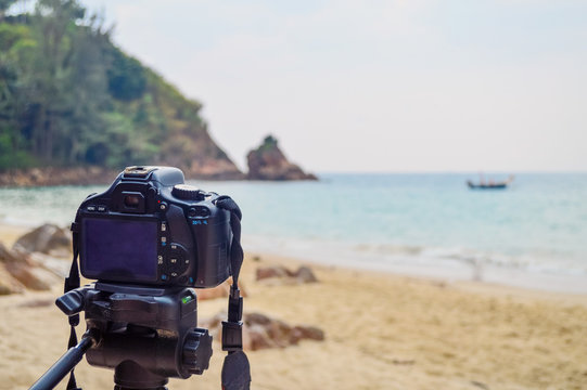 Camera on a tripod outdoors taking photo of beautiful beach