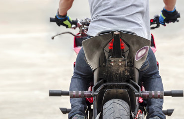 Naklejka premium cropped image of man driving motocycle