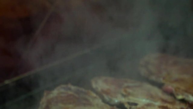 Slow motion cheff is cooking a Steak in hot Griddle of a kichen. Slowmo T-bone steak is low fat healthy living meal choice-Dan