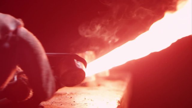 Torch being lit by sparker on anvil