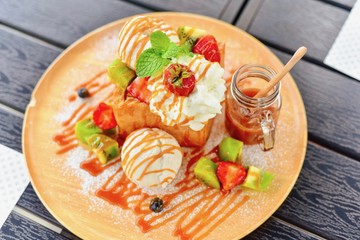 Fototapeta na wymiar Top View of Honey Toast with Butterscotch Sauce on a Wooden Platter