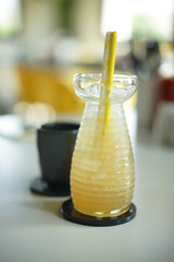 Glass of fresh lemongrass ginger tea with straw
