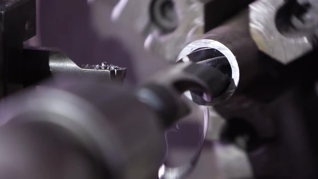 Metal lathe drilling into metal road and smoking