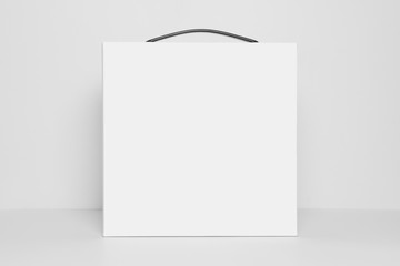 Mockup of empty white square box with carrying handle, front view, isolated on a white background