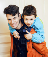 young handsome father with his son fooling around at home, lifes
