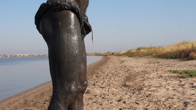 Mud Cure. Bather Covered With Mud At The Lake Of Salt Water