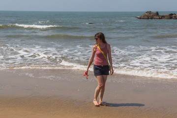 Young woman on the coast of the Arabian Sea, Indian Ocean, North Goa, India