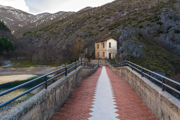 Fototapeta premium Villalago (Abruzzo, Italy) - A charming little medieval village in the province of L'Aquila, situated in the gorges of Sagittarius, between Lake Scanno and Lago San Domenico, with bridge of sanctuary
