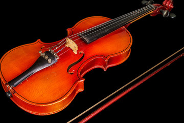 Fototapeta na wymiar Violin and bow isolated on black background