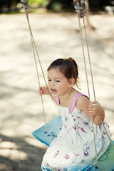Girl riding on a swing 