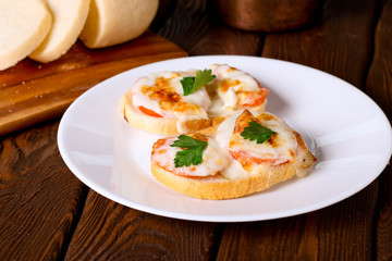Toasted sandwich with cheese and tomato.