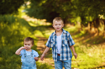 children walk in a Park , Brother and sister on a summer walk