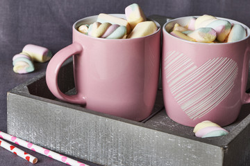 Two pink cup with cocoa and