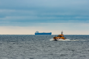 Fototapeta premium Orange pilot ship moving at speed in Baltic sea