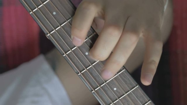 Guitar strings closeup. A man plays gitare