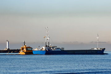 Fototapeta premium Blue cargo ship leaving Riga and entering Baltic sea