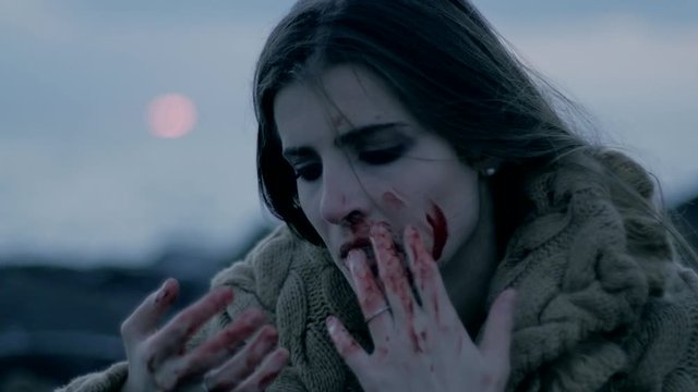 Crazy female serial killer looking blood extreme closeup