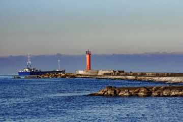 Blue cargo ship leaving Riga and entering Baltic sea