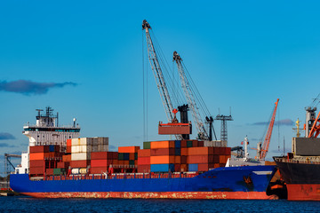 Blue container ship loading in cargo port of Europe