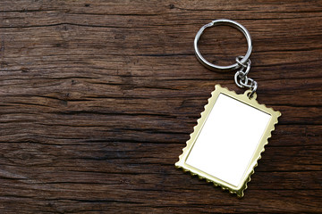 Metal key chain with space for text on wooden