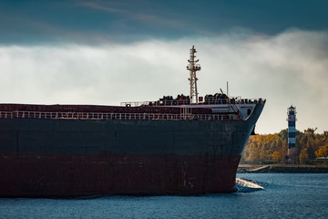 Fototapeta premium Black cargo ship's bow entering Riga, Europe