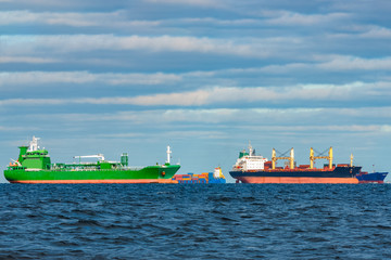 Cargo ships moored in still Baltic sea water