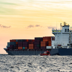 Blue container ship leaving Riga and entering Baltic sea