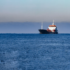 Fototapeta premium Black cargo oil tanker sailing in still water from Baltic sea