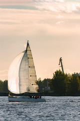 Sailboat moving on Daugava river in evening, Latvia © InfinitumProdux