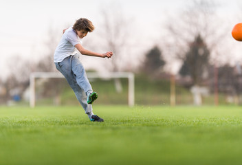 Obraz premium Kids soccer football - children player on soccer field