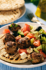 Greek meatballs (keftedes) with pita bread and tzatziki dip.