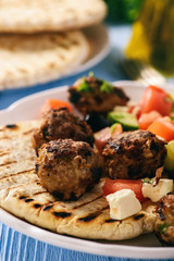Greek meatballs (keftedes) with pita bread and tzatziki dip.
