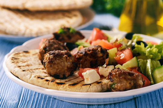 Greek meatballs (keftedes) with pita bread and tzatziki dip.