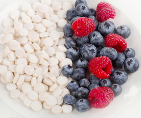 Pills or berries. Choice from  sources of vitamins. Nutrients.