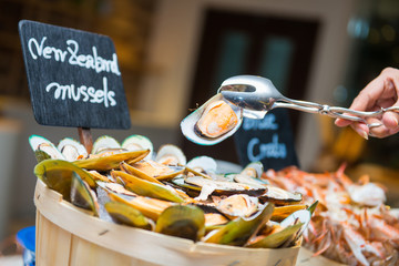 New zealand mussels on wooden bowl