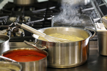 Chef in hotel or restaurant kitchen cooking
