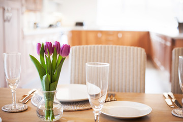 table setting with tulips in bright kitchen