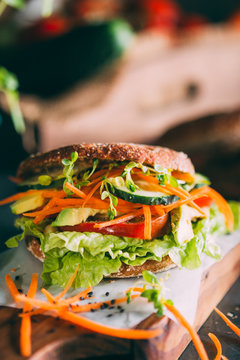 Vegetarian sandwich with lettuce, cucumber, carrot tomato anda avocado
