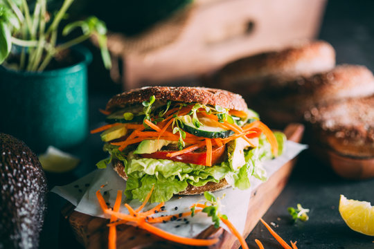 Vegetarian sandwich with lettuce, cucumber, carrot tomato anda avocado