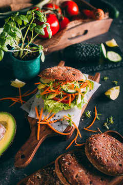 Vegetarian sandwich with lettuce, cucumber, carrot tomato anda avocado